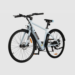 White VARUN C7007 Premium Commuter Electric bicycle on a light gray background - Pogo Cycles, Ireland
