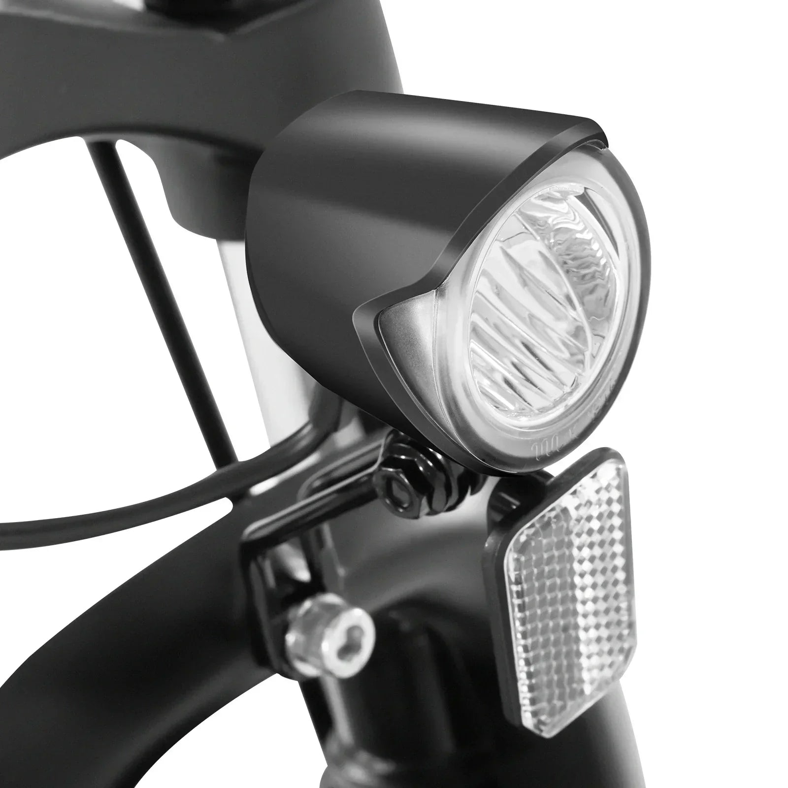 Close-up of a bicycle headlight and reflector on a white background
