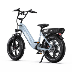 A light blue Onesport OT08 electric fat-tire bicycle with black components, a rear cargo basket, and a kickstand, photographed on a clean white background.