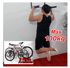 A person hanging in the mount rack to check the weight capacity which can hold up to 2 bikes or with max 100 kg.